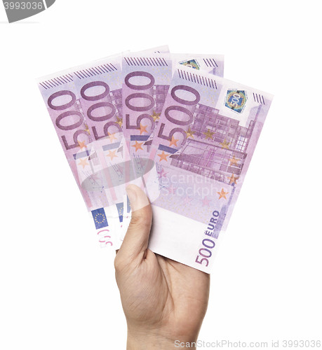 Image of Male hand holding four 500 euro notes isolated