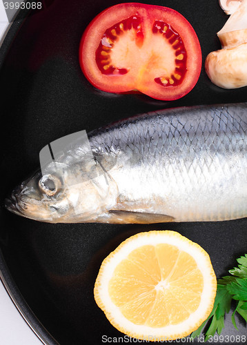 Image of fish in pan with vegetables