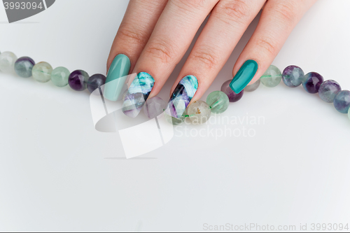 Image of Closeup of woman hand with colorful nails