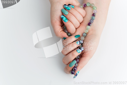 Image of Closeup of woman hands with colorful nails