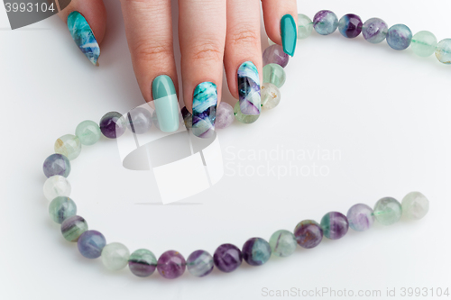 Image of Closeup of woman hand with colorful nails