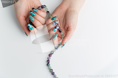 Image of Closeup of woman hands with colorful nails