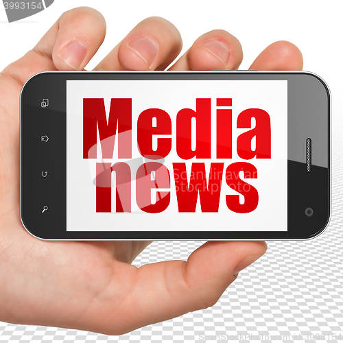 Image of News concept: Hand Holding Smartphone with Media News on display