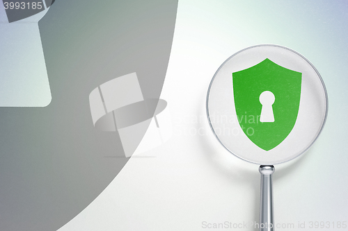 Image of Protection concept:  Shield With Keyhole with optical glass on digital background