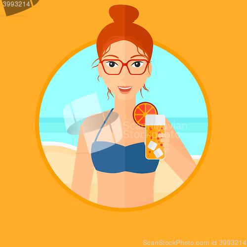 Image of Woman with cocktail on the beach.