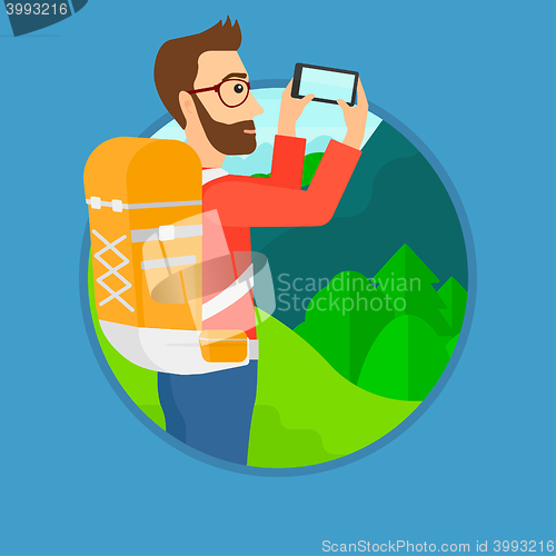 Image of Man with backpack taking photo.