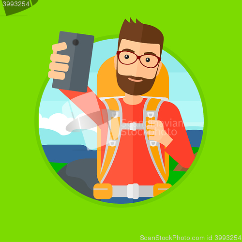 Image of Man with backpack making selfie.