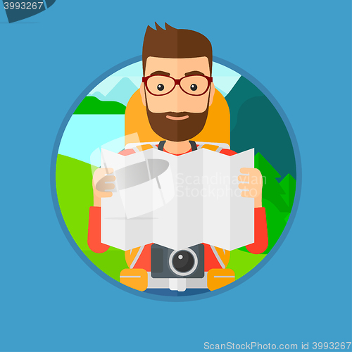 Image of Traveler with backpack looking at map.
