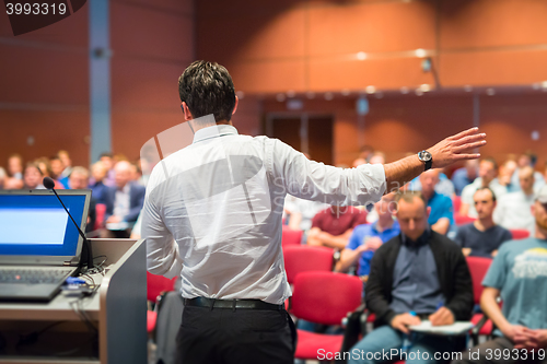 Image of Public speaker giving talk at Business Event.