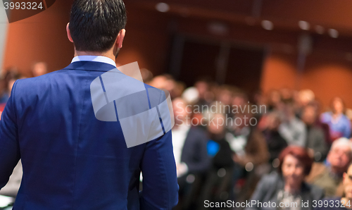 Image of Public speaker giving talk at Business Event.