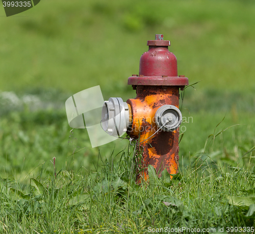 Image of Red fire hydrant on a city sidewalk