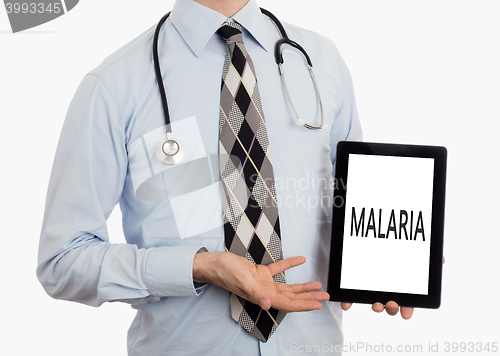 Image of Doctor holding tablet - Malaria