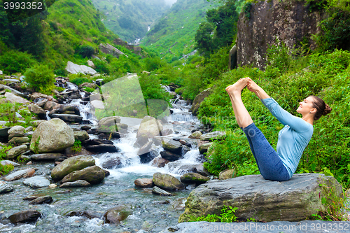 Image of Woman doing Ashtanga Vinyasa Yoga asana outdoors