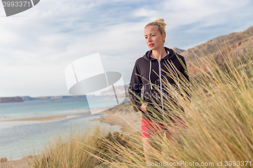 Image of Relaxed Happy Woman Enjoying Walk on Beach