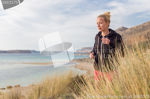 Image of Active Woman Jogging on Beach