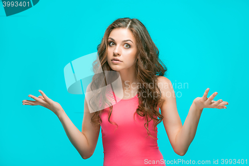 Image of Portrait of young woman with shocked facial expression