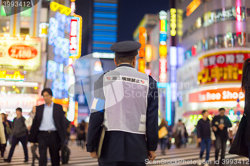 Image of Japanese policeman standing in Shinjuku, Tokyo, Japan.