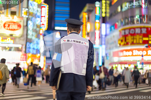 Image of Japanese policeman standing in Shinjuku, Tokyo, Japan.