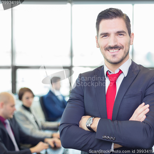 Image of Team leader with coworkers working in office.