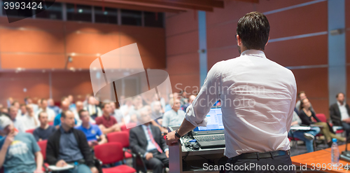 Image of Public speaker giving talk at Business Event.