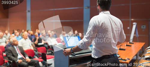 Image of Public speaker giving talk at Business Event.