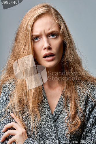 Image of Closeup of angry woman on gray background