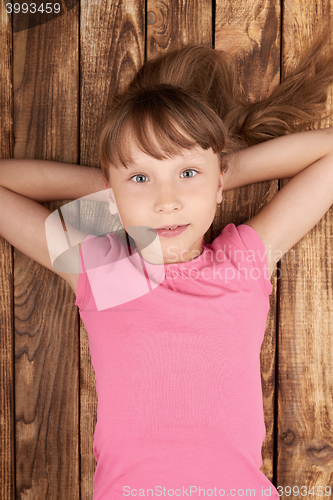 Image of Top view of a little girl lying on back