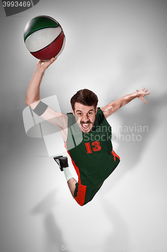 Image of Full length portrait of a basketball player with ball