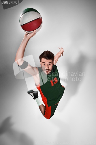 Image of Full length portrait of a basketball player with ball