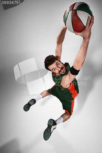 Image of Full length portrait of a basketball player with ball