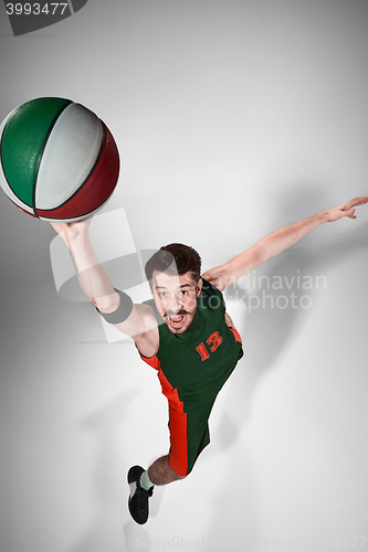 Image of Full length portrait of a basketball player with ball