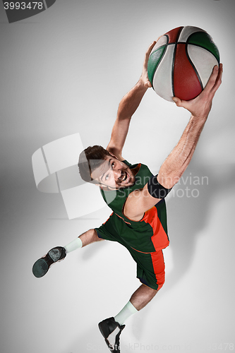 Image of Full length portrait of a basketball player with ball