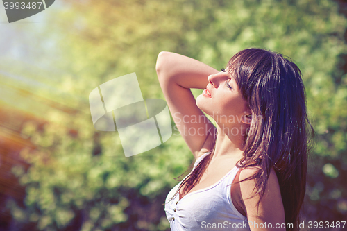 Image of Woman enjoying with closed eyes outdoors