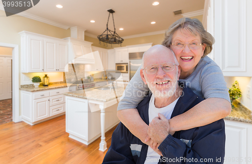 Image of Senior Couple Hugging Inside Custom Kitchen