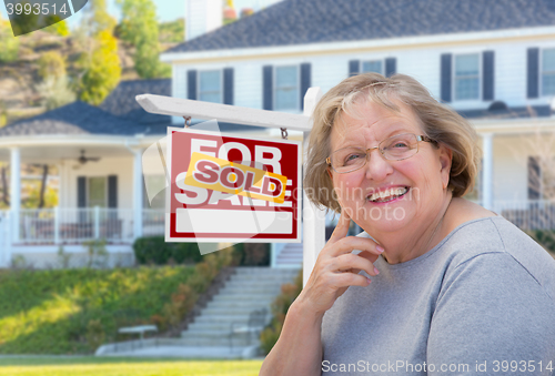Image of Senior Adult Woman in Front of Real Estate Sign, House