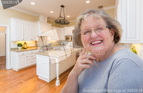 Image of Happy Senior Woman In Custom Kitchen Interior