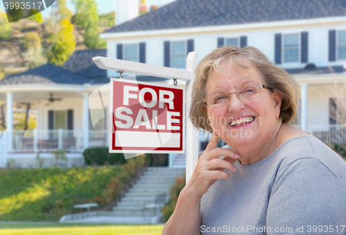 Image of Senior Adult Woman in Front of Real Estate Sign, House