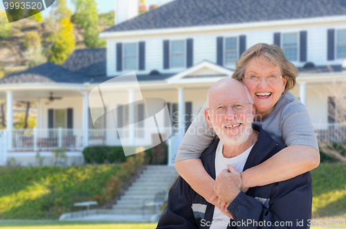 Image of Happy Senior Couple in Front of House