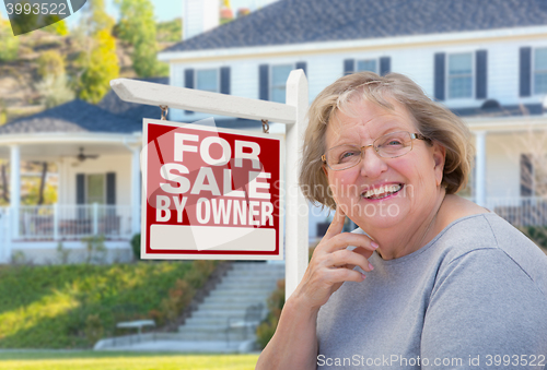 Image of Senior Adult Woman in Front of Real Estate Sign, House