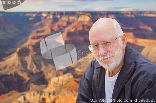 Image of Happy Senior Man Posing on Edge of The Grand Canyon