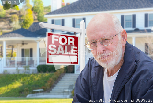 Image of Senior Adult Man in Front of Real Estate Sign, House