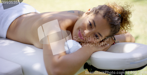 Image of Woman laying down on massage table at spa