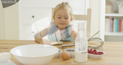 Image of Cute baby baking in a kitchen