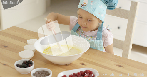 Image of Adorable toddler at mixing bowl