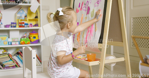 Image of Little girl painting with her hand