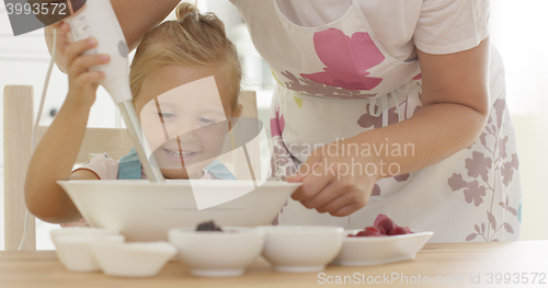 Image of Cute happy little girl helping with the baking