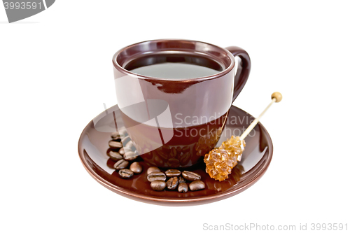 Image of Coffee in brown cup with sugar and grains