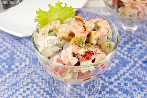 Image of Salad with shrimp and tomatoes in glass on linen tablecloth