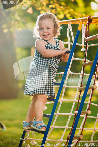 Image of The little baby girl playing at outdoor playground