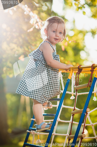 Image of The little baby girl playing at outdoor playground